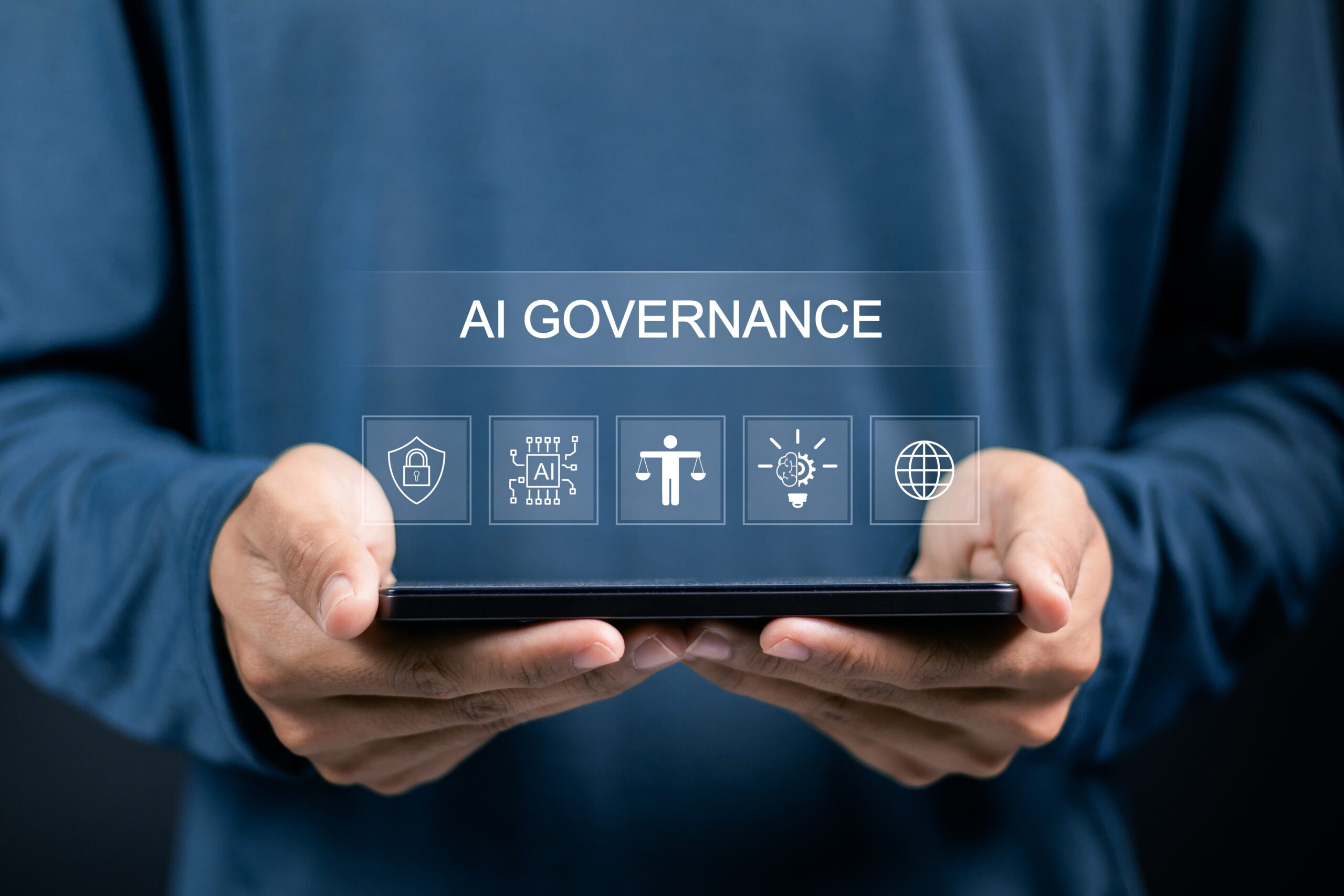 Person holding a tablet with a translucent banner reading 'AI GOVERNANCE' and icons for security, AI, ethics, and global connectivity.